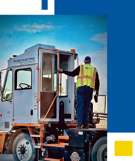 Wagner Employee standing on back of large truck.