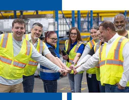 Wagner Logistics team members giving a group fist bump in the warehouse